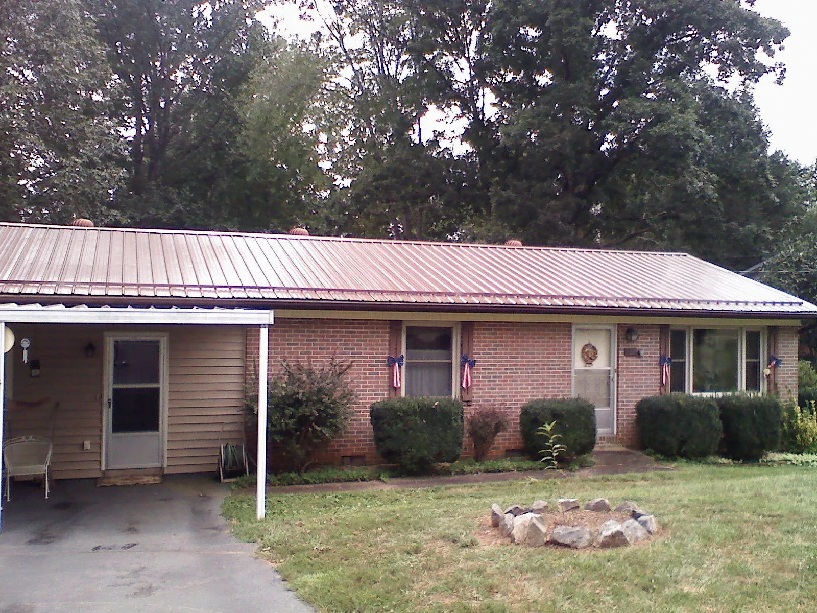 Bronze metal roof and carport on a brick ranch home — Roof Repair work by our crew in Humarock